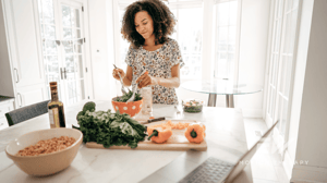 A woman cooks at her kitchen island.