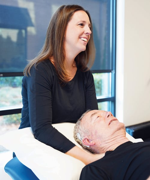 Physical therapist performing cervical manual therapy on senior patient in Homewood Alabama physical therapy clinic.