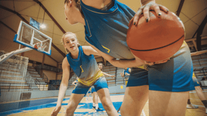 Two teenage girls on a basketball court